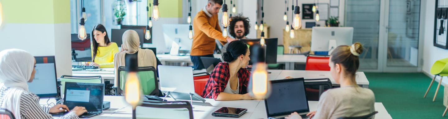 Group of young business people working and communicating together in creative office