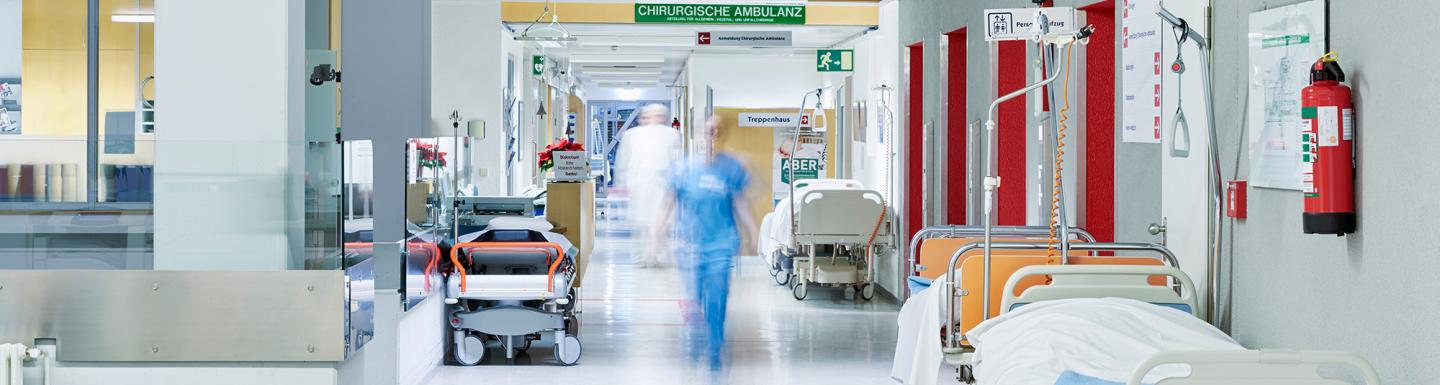 hospital corridor with blurred person walking down hallway
