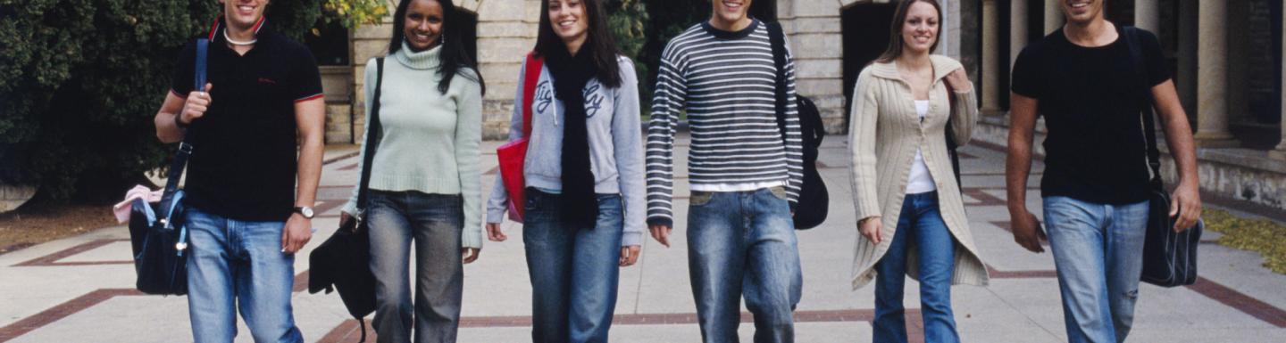 A group of college students walking through their University 
