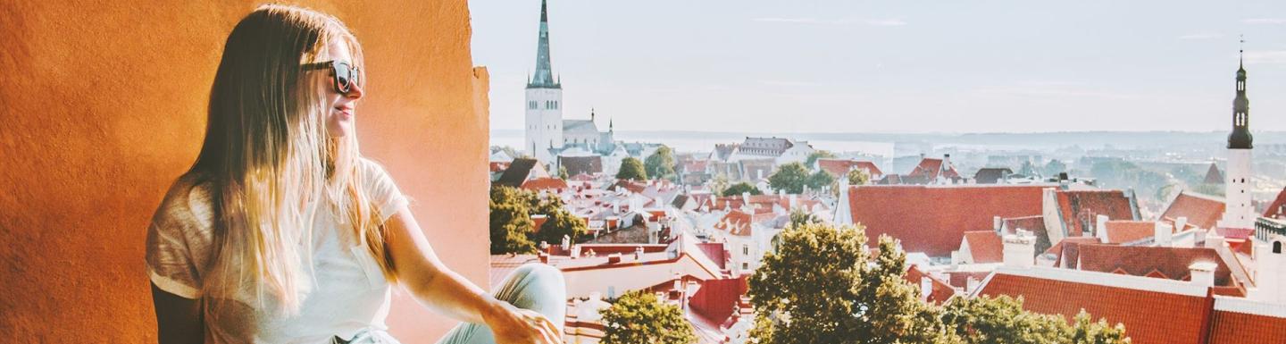 Overlooking Tallinn, a woman on the left is looking from a window