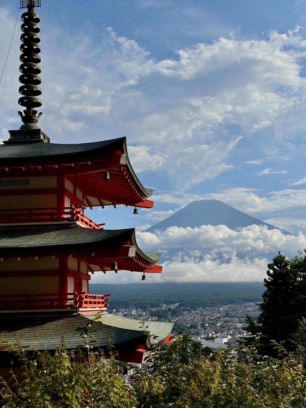 Red Japanese temple with Mount Fuji in the skyline
