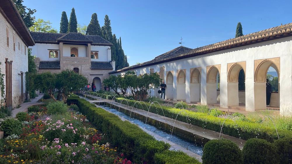 Landscape shot of the Alhambra gardens and fountains during the day