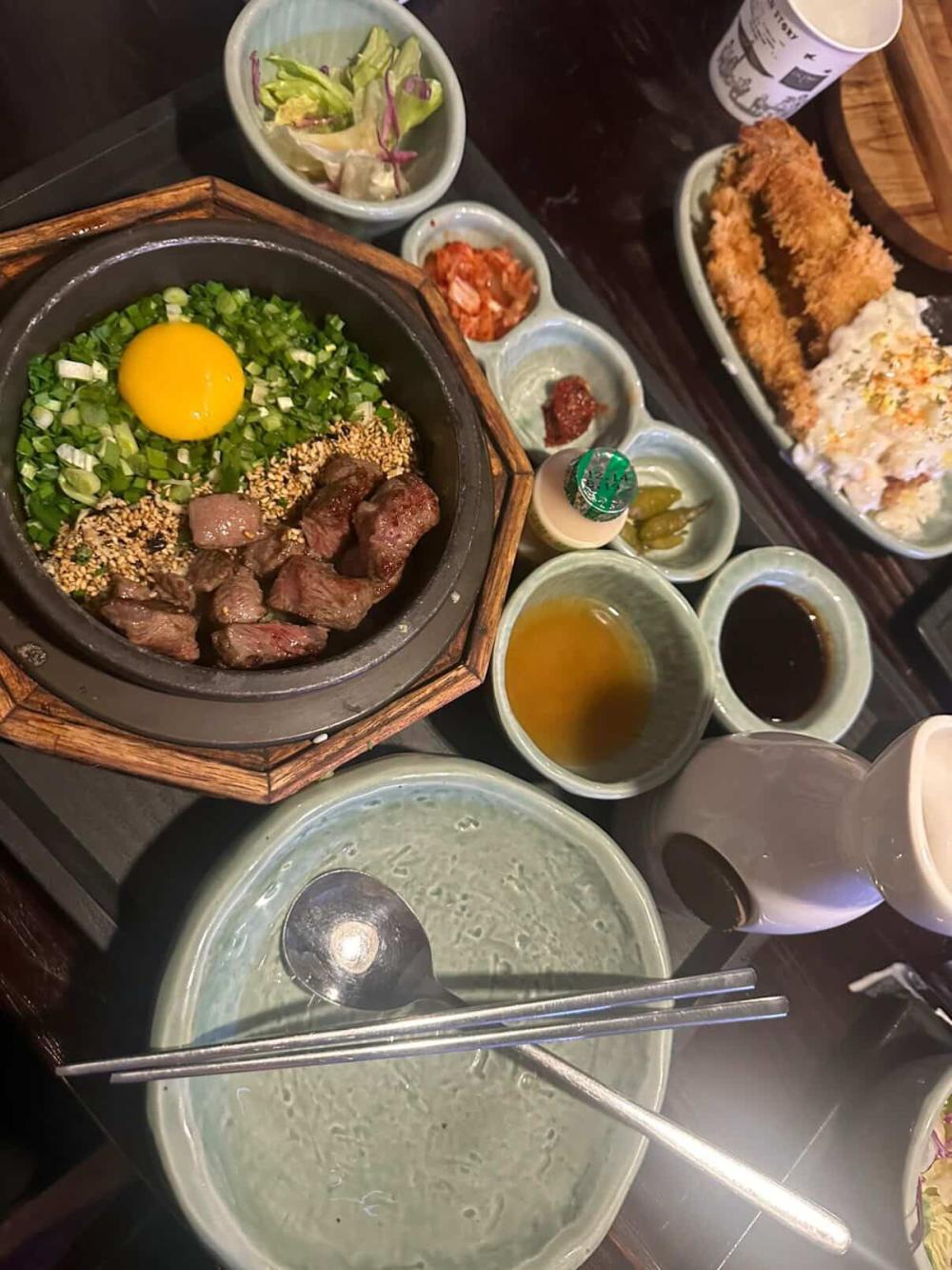 Delicious meal in Korea with meat, an egg, and vegetables.