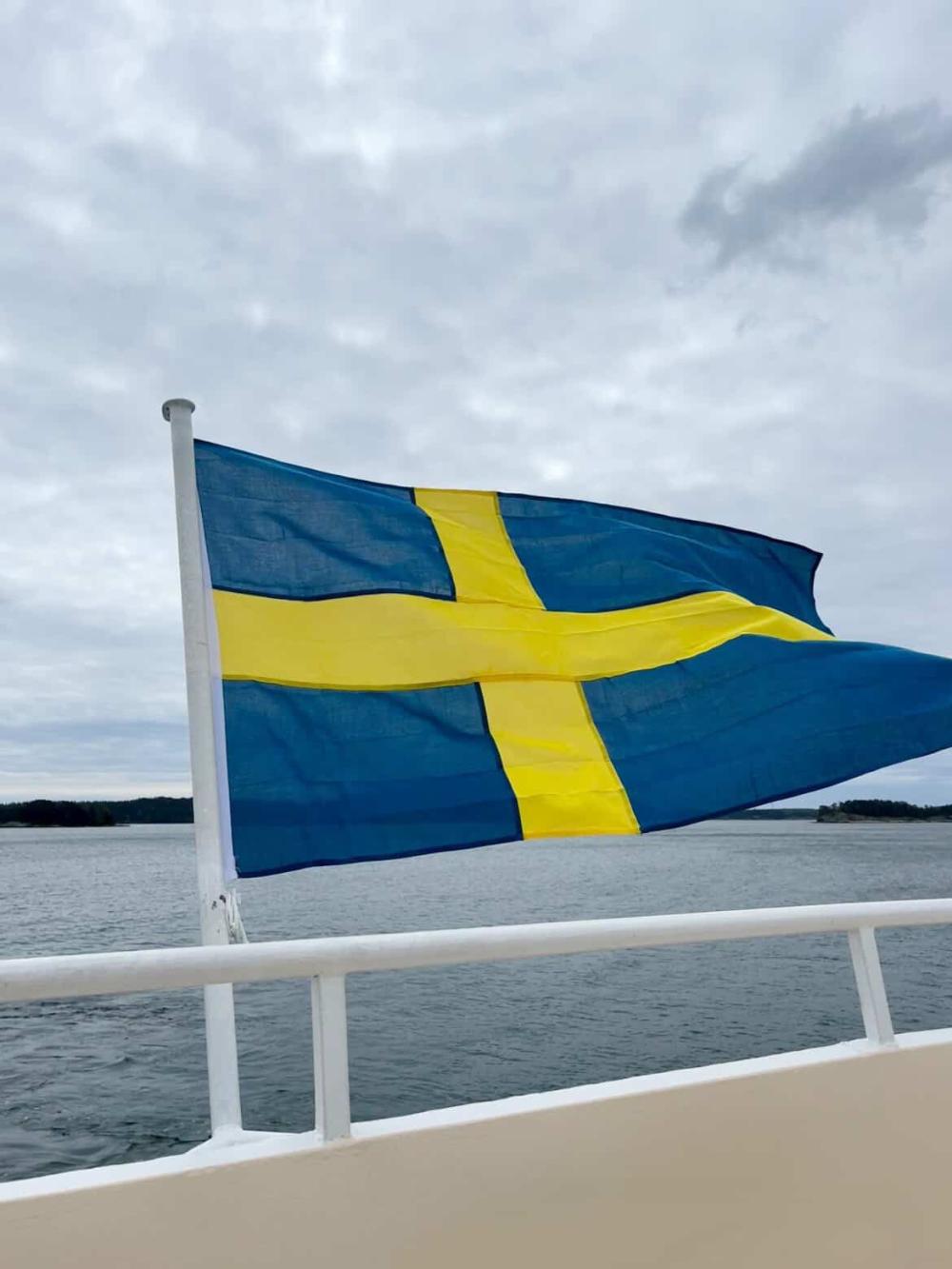 Swedish flag waving in the wind on a boat in Europe