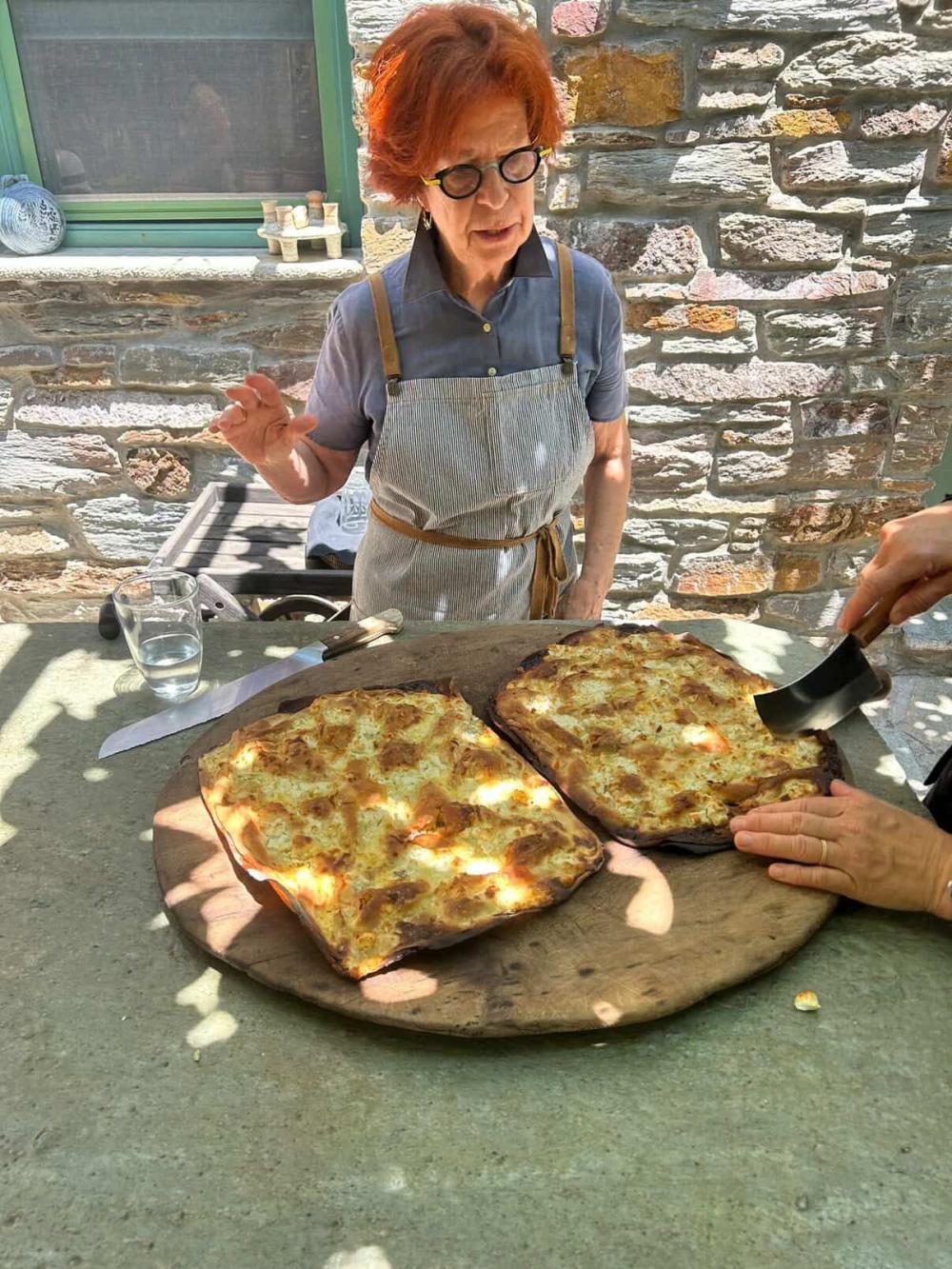 Cooking class in Greece with a local teacher displaying bread