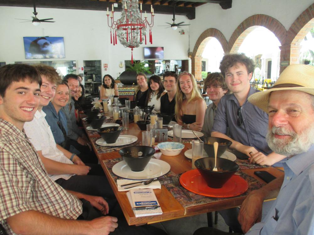 Professor Peter Laufer and UO journalism students sharing a meal during a study abroad program
