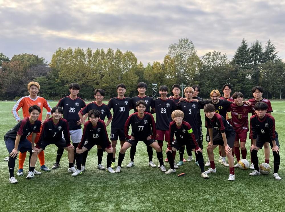 Group photo of a youth soccer team on a grass field, with players wearing different colored jerseys, some numbered, posing for the camera.