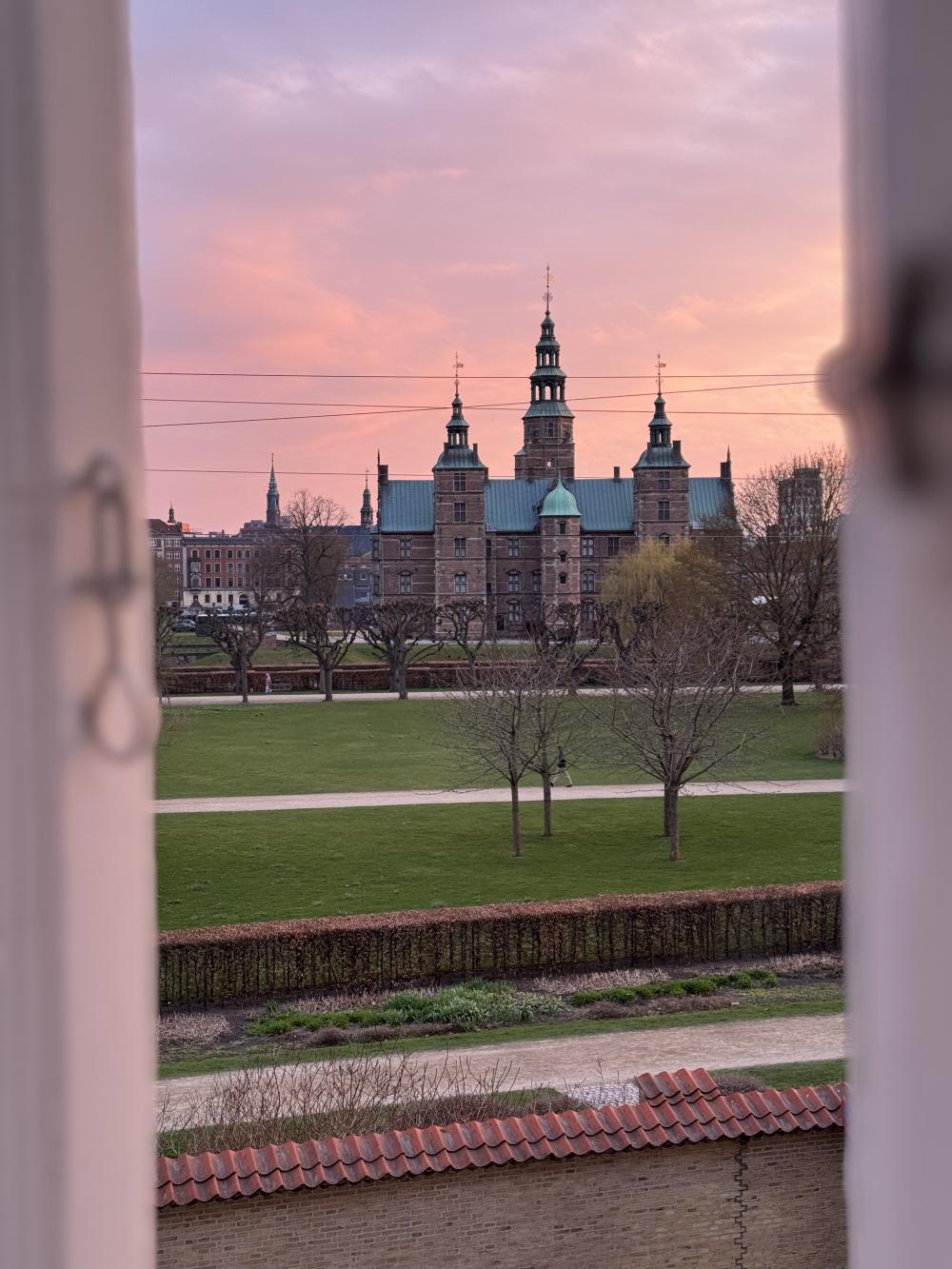 Scandinavian buildings under a pink sky during sunset