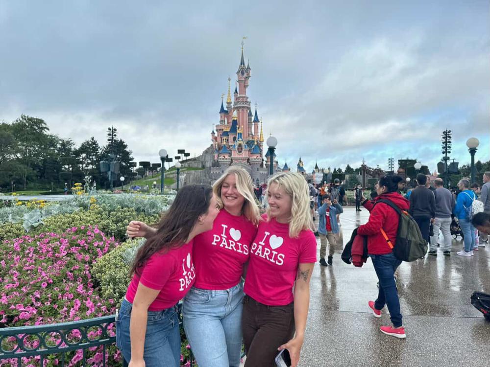Three students at Disneyland Paris wearing pink "I Heart Paris" t-shirts
