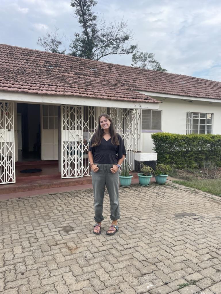 Sadie standing outside of a building in Kisumu, Kenya