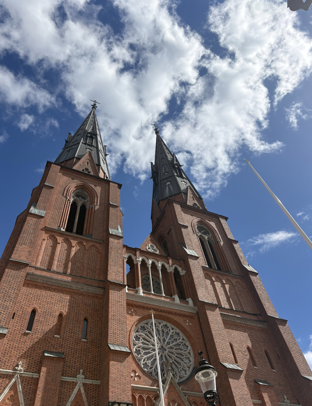 Upward view shot of a brick cathedral in Stockholm under a partly cloudy sky