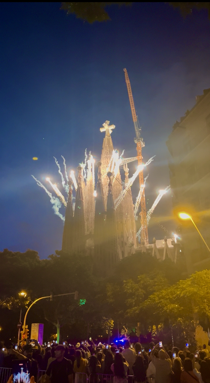 The Sagrada Familia Church at night with fireworks in the background