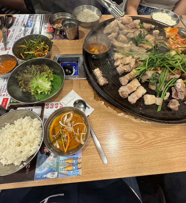 a barbecue spread with various banchan