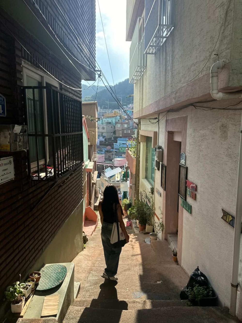 Vy walking down steps in a Korean town