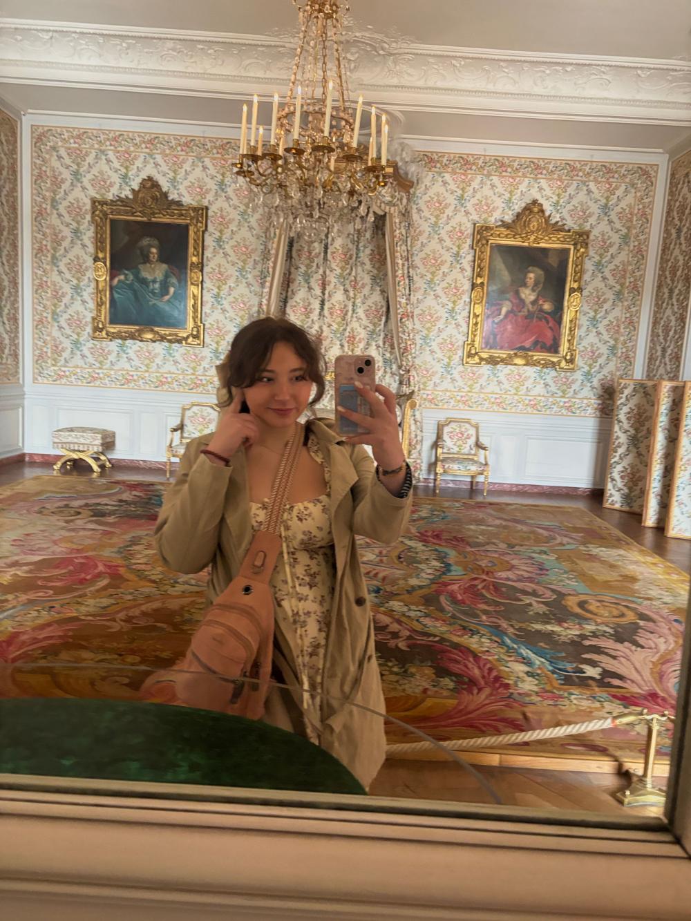 Giana taking a selfie in a bedroom inside the palace of Versailles