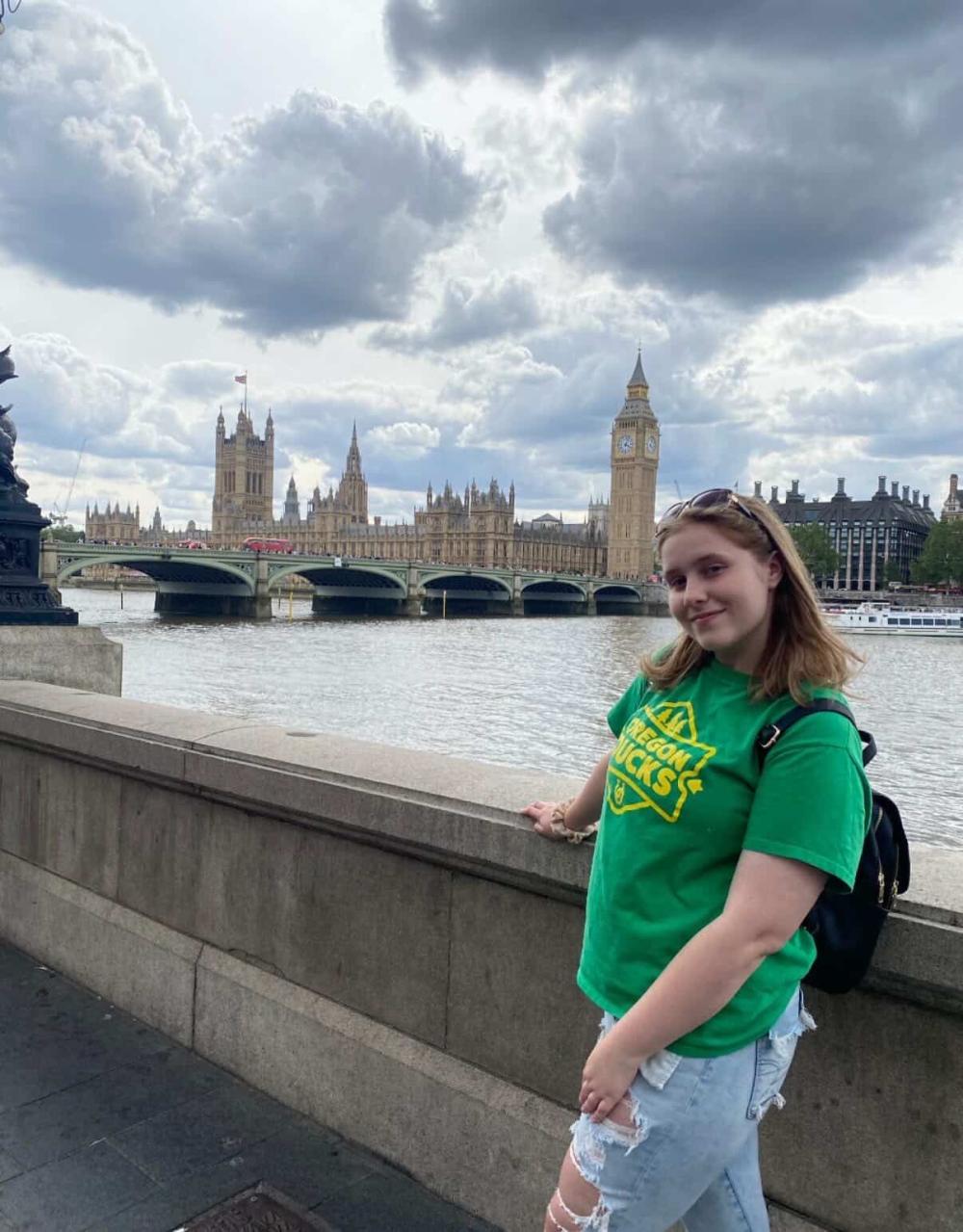 Chloe smiling by the River Thames with the Big Ben in the skyline
