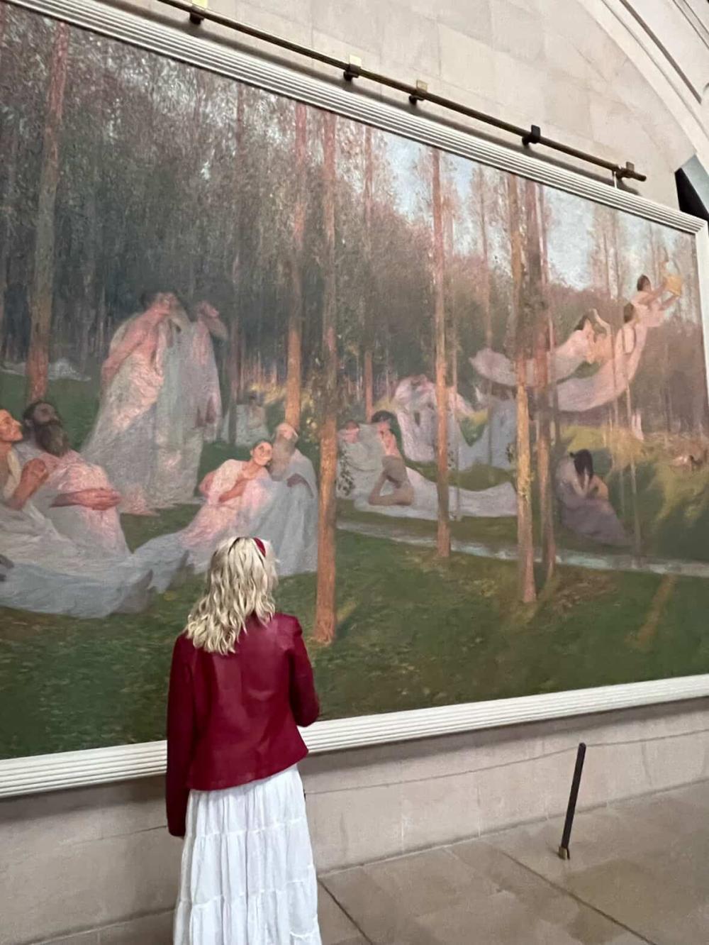 Katie admiring a painting in Paris
