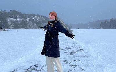 Annika with their arms out in the snow in Europe