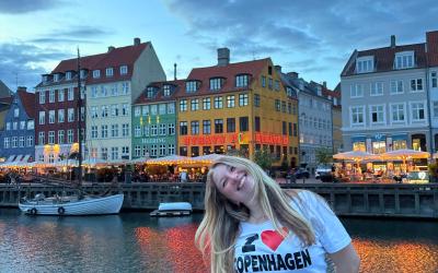 Frances smiling in Denmark wearing an "I Heart Copenhagen" shirt. 