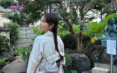 Evelyn smiling in a garden wearing traditional Japanese robes