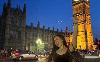 A night time scene at the big ben with a uo student standing in front