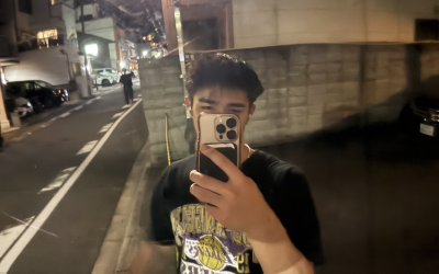 A uo student taking a mirror selfie on the street in Japan