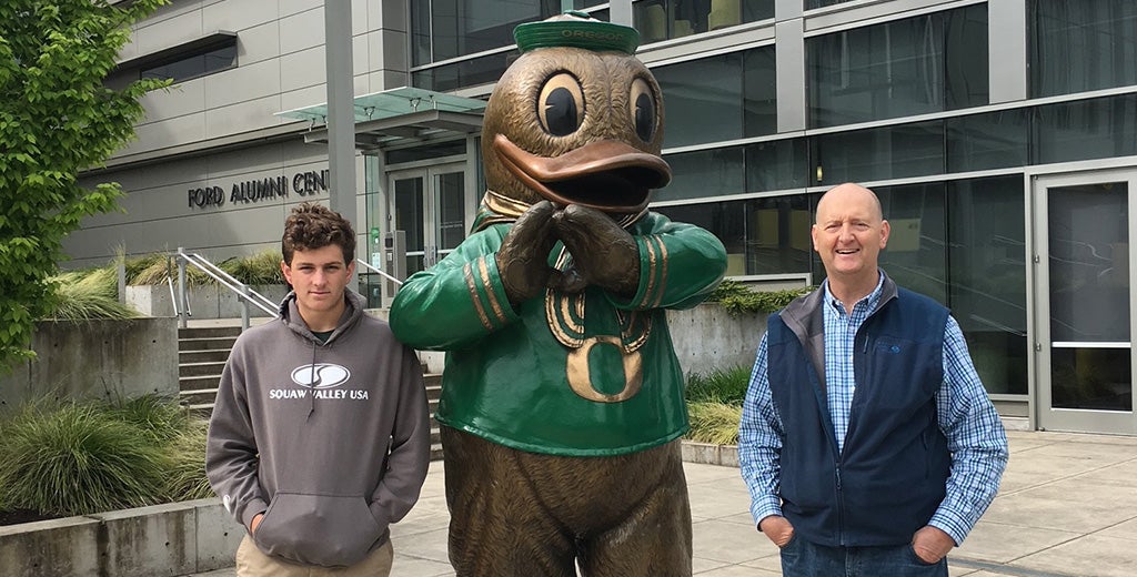 Casey and Phil Estes next to bronze Duck statue