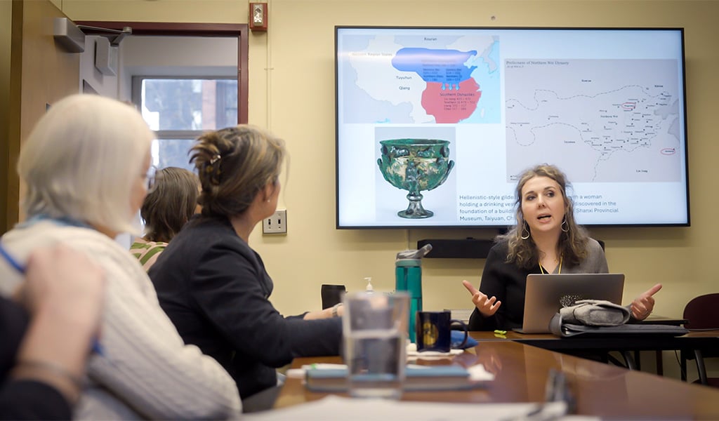 Woman giving a presentation around a table