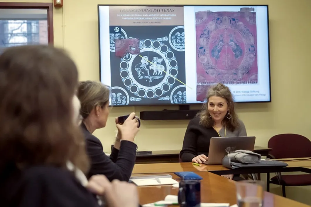 Woman giving a presentation around a table