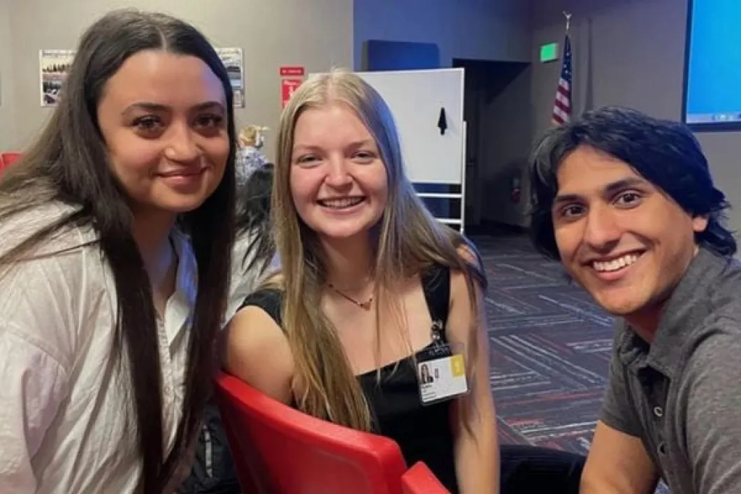 Three human physiology student interns smiling at camera