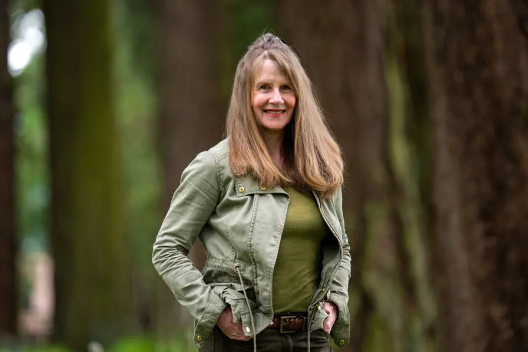 A women standing outside among trees
