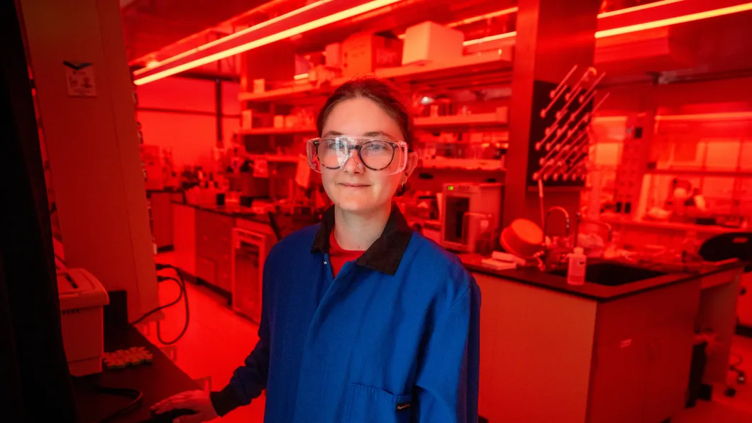 Audrey looking at the camrea smiling while in a lab room