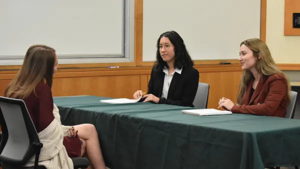 Three law students sitting at a table
