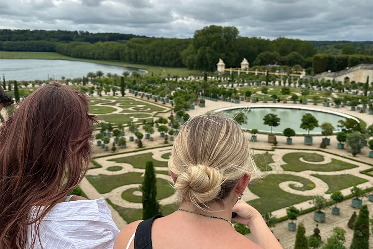 Back of two students' heads looking out to a large courtyard in Paris