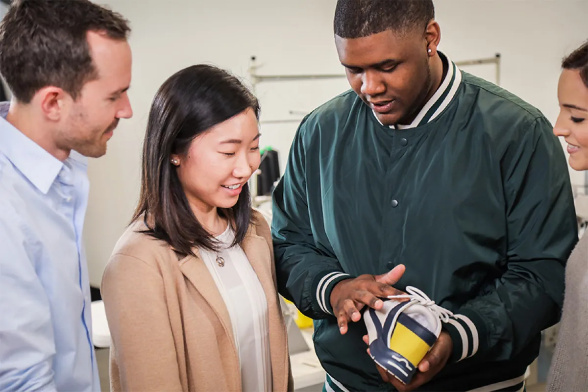 A group of UO students examine a sneaker design