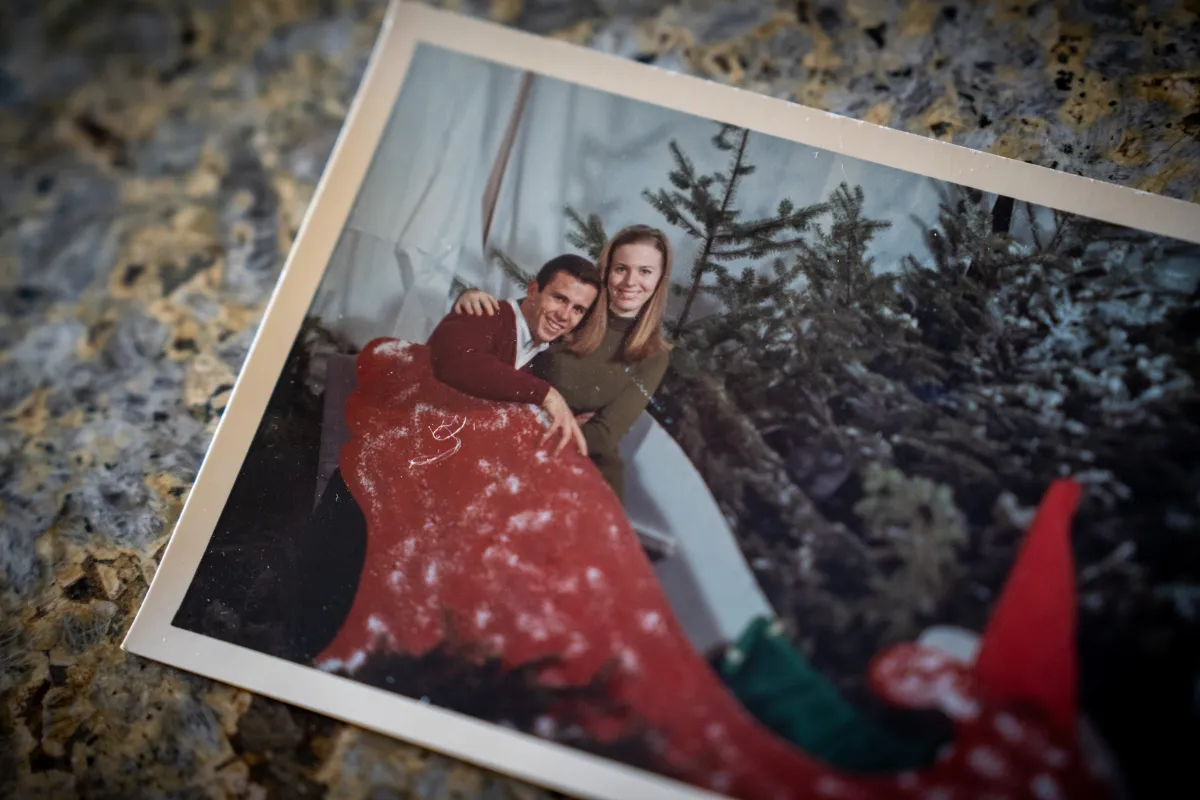 Physical photo of Nancy and Don Smith posing for a Christmas themed picture