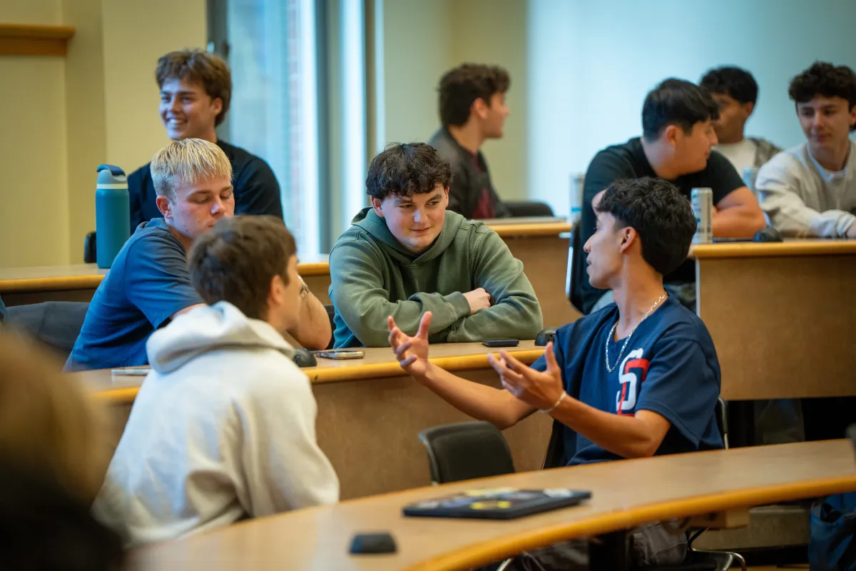 Members of the Real Estate Investment Group talk with one another during the first Spring term meeting of the group.