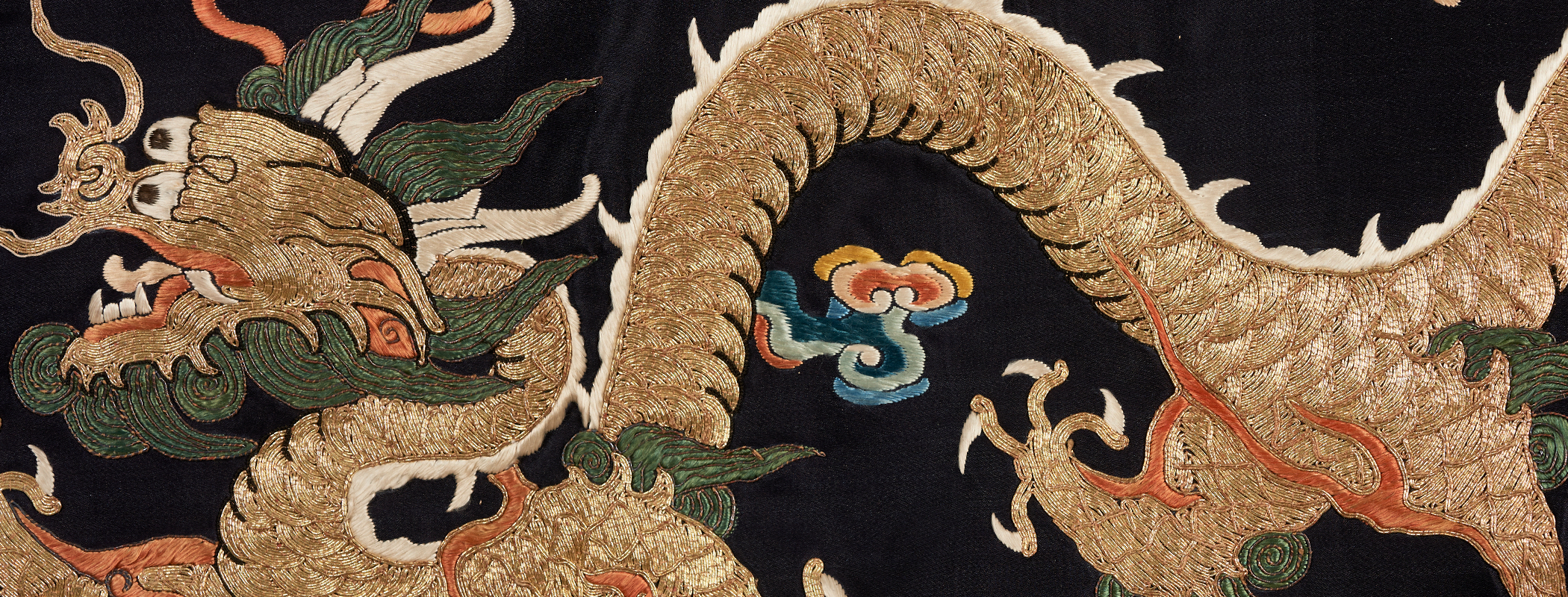 a golden dragon embroidered on a black background