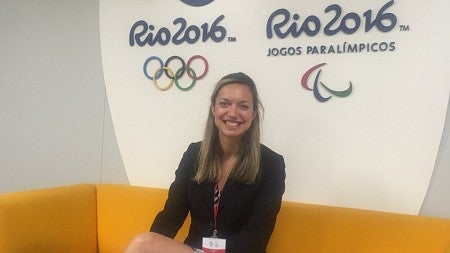 a person sitting by olympic signs