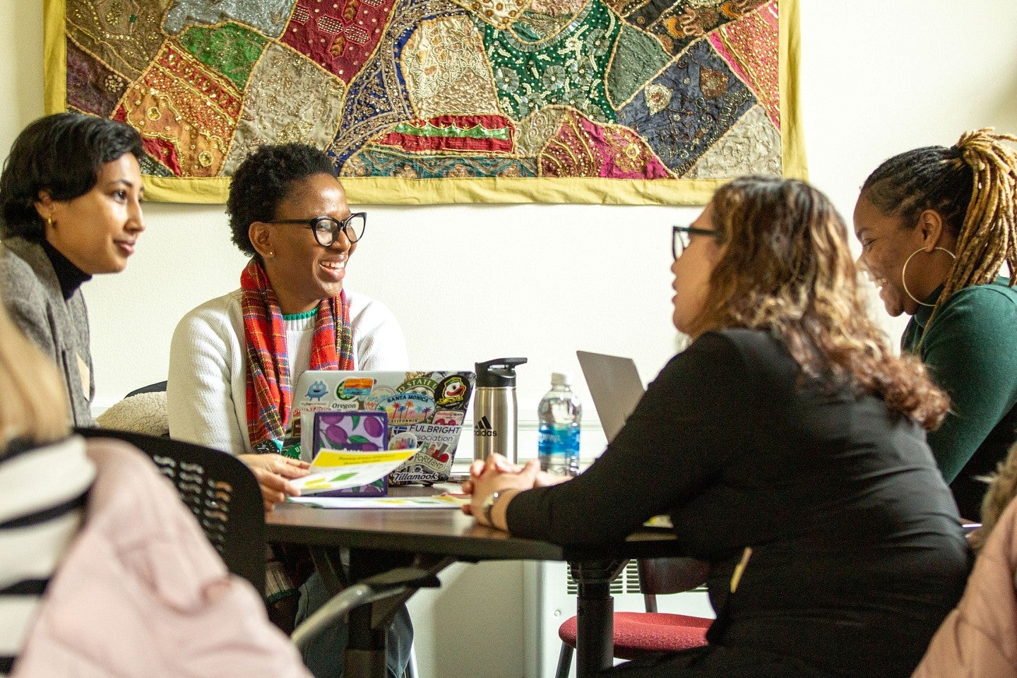 Graduate students gathering around a table