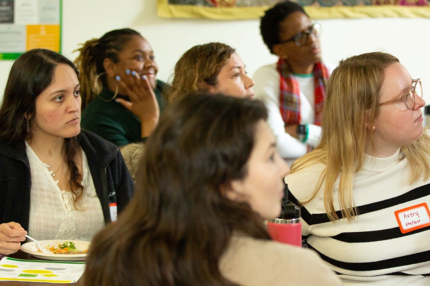 Graduate students listening to a presentation