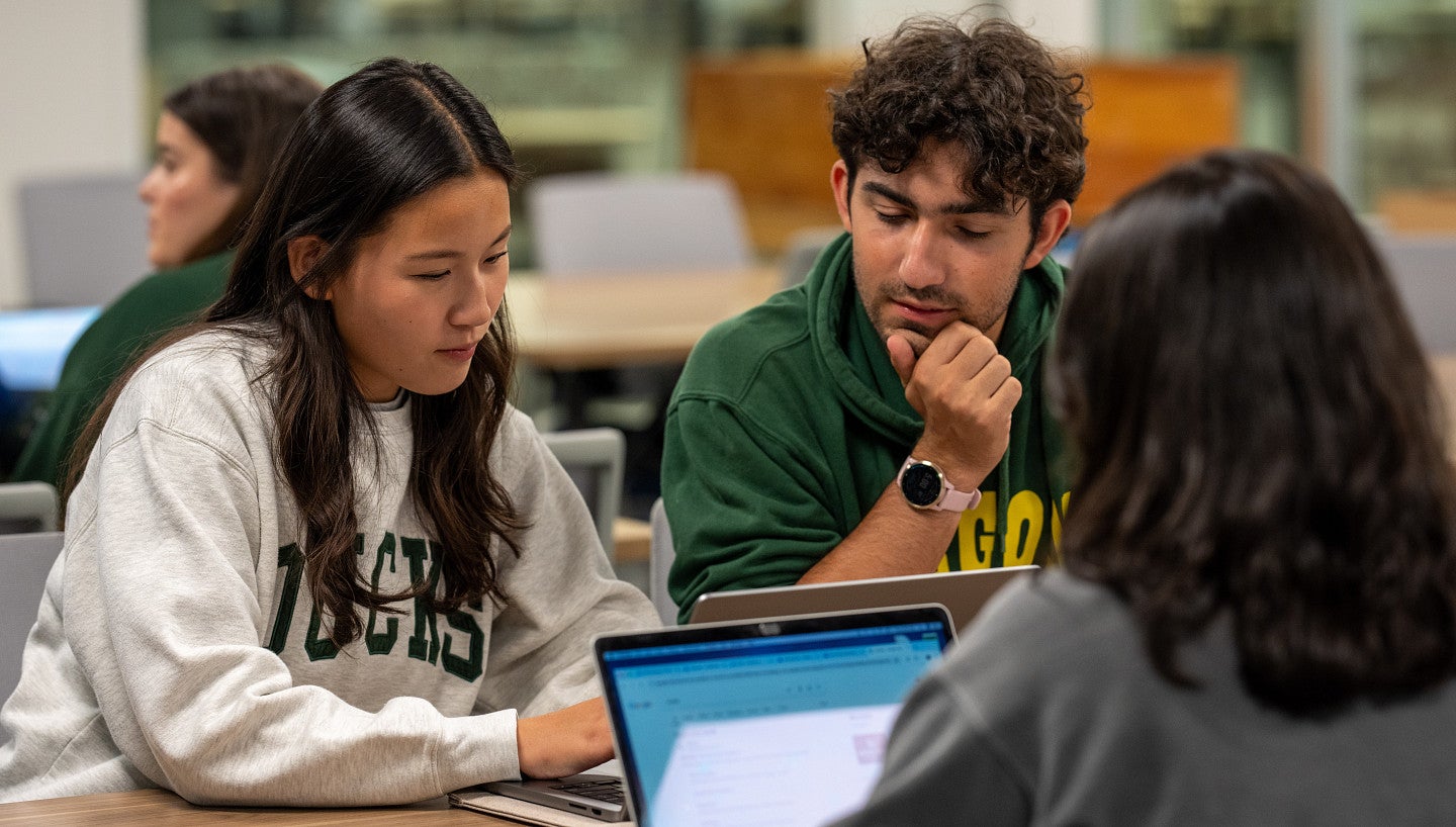 Students working at a table in the library.