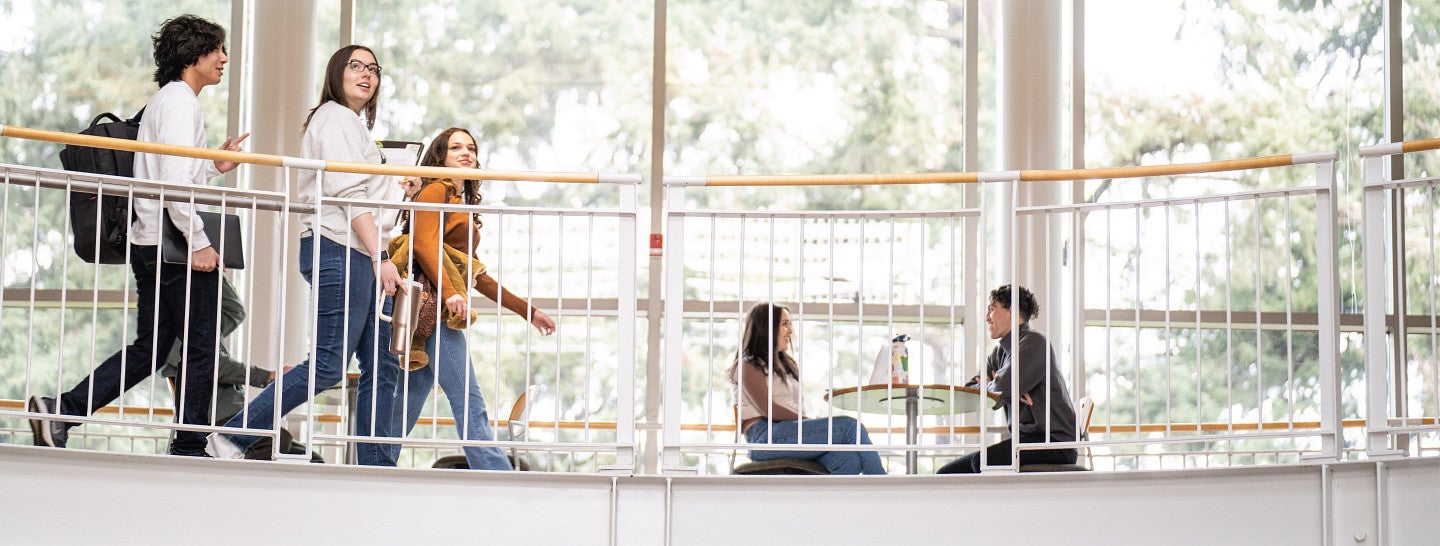 Three students walking together in Lillis.