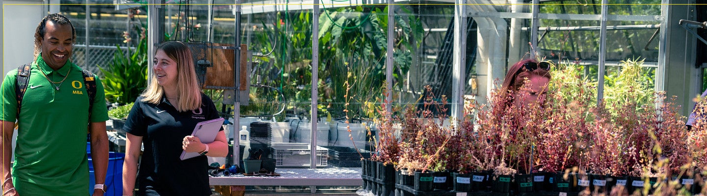 Two MBA students touring a greenhouse.
