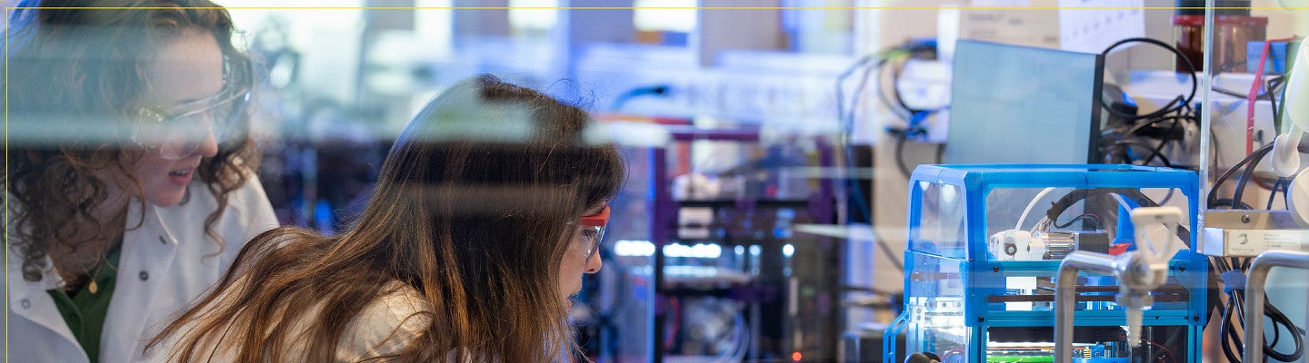 Two students working in a lab.