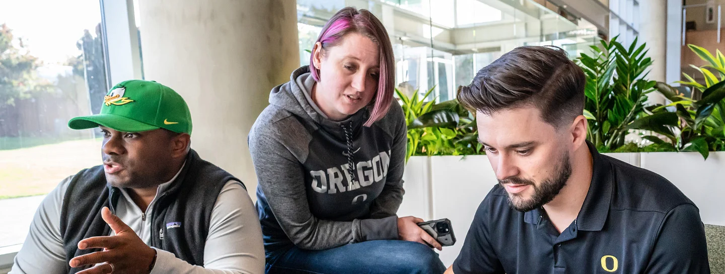 Three students sit together on the Portland campus.
