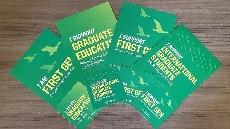 4 door signs and 4 stickers for the graduate student visibility campaign showing support for graduate education, international students, and first gen students.