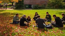 Students in cirlce on lawn