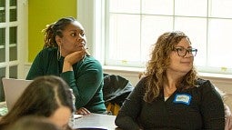 Graduate students listening to a presentation
