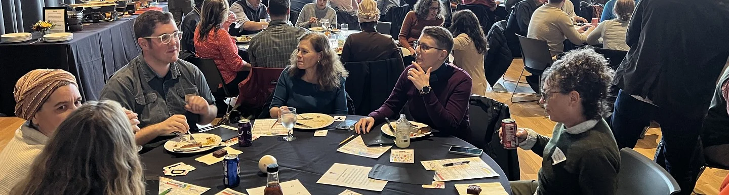A group of University of Oregon employees sitting a tables for a lunch hosted by GSI